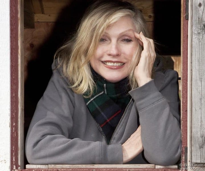 Debbie looks as cute as ever looking out of a country house window.