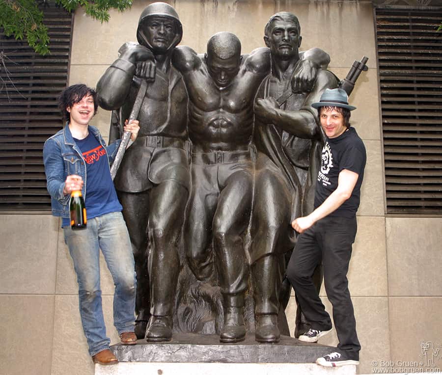 Ryan gets a bottle of champagne and celebrates with Jesse on the Coast Guard Statue in the park.