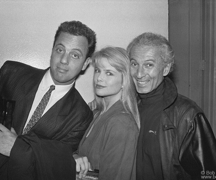 Billy Joel, Christie Brinkley and Ron Delsener, Beacon Theatre, NYC. April 1987. <P>Image #: NewYorkMusicAwards487_1-4a_1987  © Bob Gruen