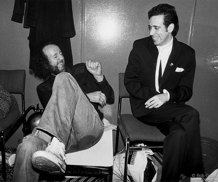 Guy Stevens and Mick Jones, Hammersmith Odeon, London, England. December 27, 1979. <P>Image #:Clash1279_4-25_1979 © Bob Gruen
