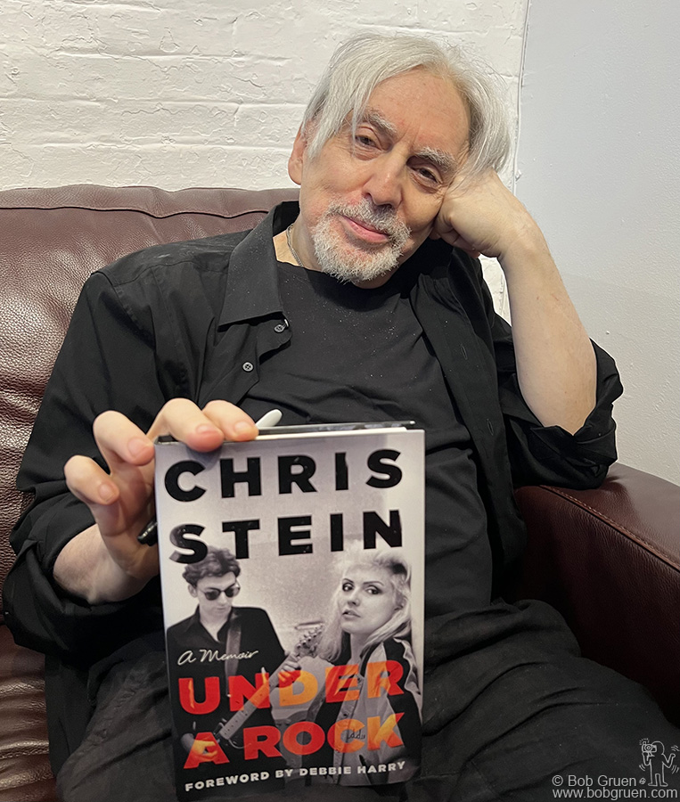 June 26 - NYC - Chris Stein of Blondie posing with his autobiography book “Under A Rock” during the launch party at Morrison Hotel Gallery.