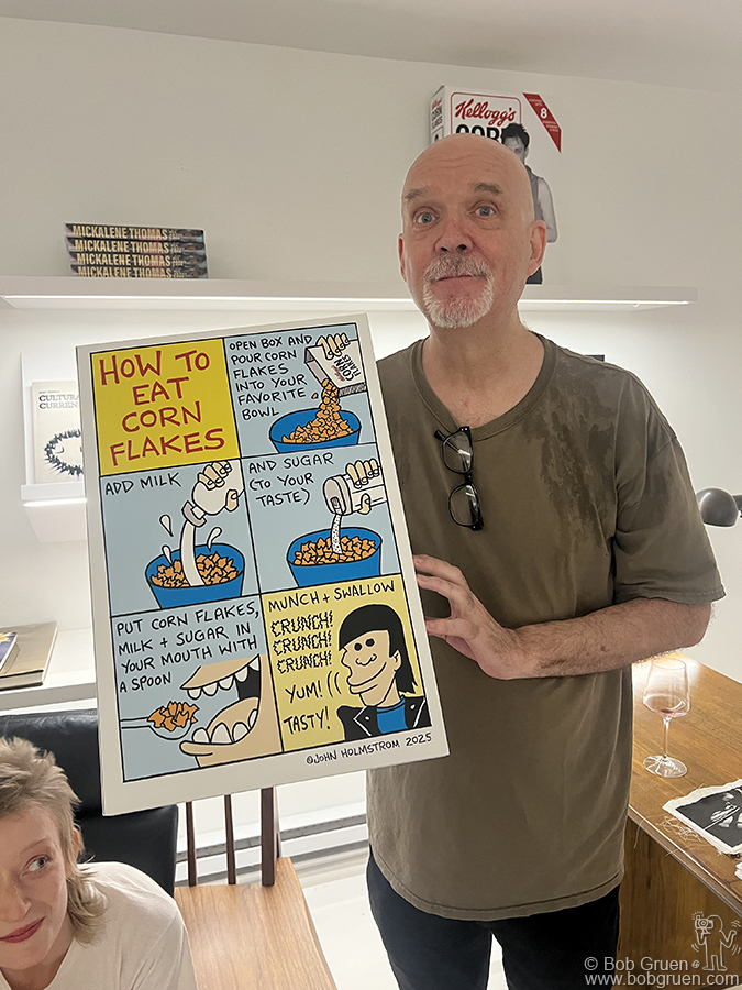 July 30 - NYC - John Holmstrom with his piece at Bobby Grossman’s exhibit at Atelier Jolie. Bobby made portraits of rock stars eating  Kellogs Corn Flakes and printed the photos on a simulated big box of Corn Flakes and John made a cartoon of how to eat them for the back of the boxes.