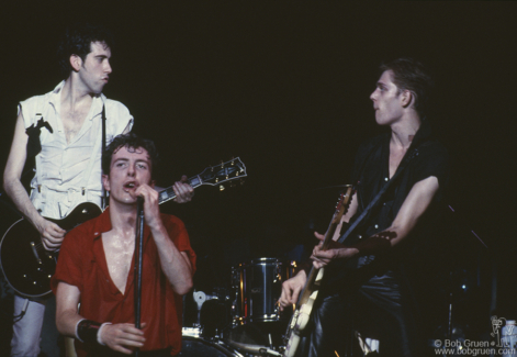 (L-R) Mick Jones, Joe Strummer and Paul Simonon of the Clash on stage during their tour of the USA. March 1980. Image #: Clash380_1980_21 © Bob Gruen Mick Jones, Joe Strummer and Paul Simonon, USA - 1980