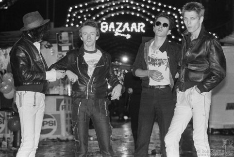 (L-R) Mick Jones, Topper Headon, Joe Strummer and Paul Simonon of the Clash at the San Gennaro Festival in NYC. September 1978. Image #: Clash978_4-6a_1978 © Bob Gruen Clash, NYC - 1978